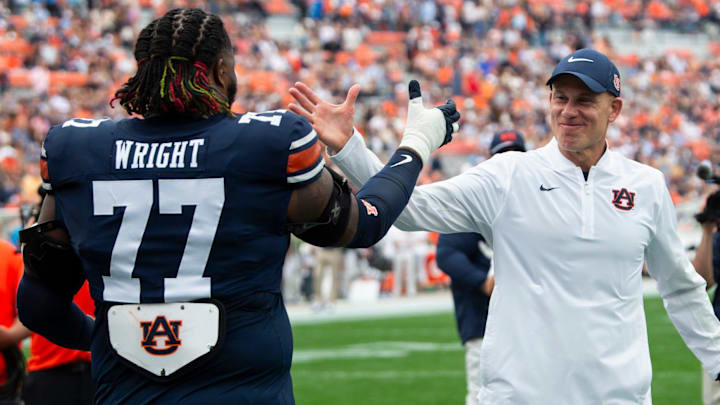 Auburn Tigers interim head coach DJ Durkin hugs offensive lineman Jeremiah Wright (77) Auburn Tigers interim head coach DJ Durkin hugs offensive lineman Jeremiah Wright (77)