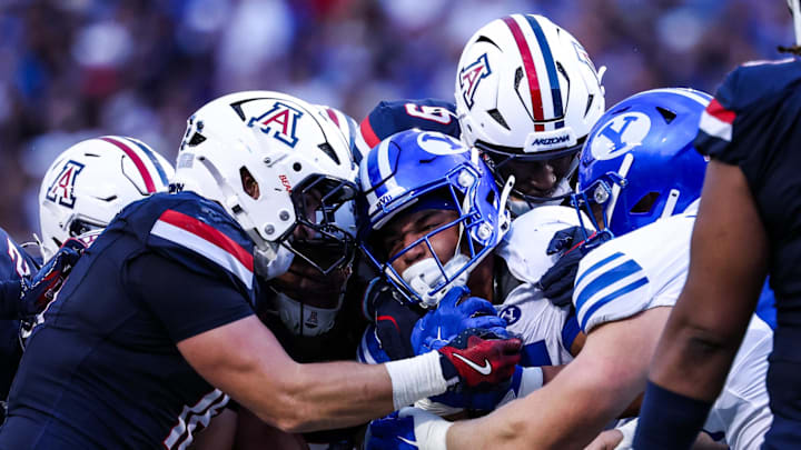 Oct 11, 2025; Tucson, Arizona, USA; Brigham Young Cougars running back LJ Martin (4) gets tackled by the Arizona Wildcats during the first quarter of the game at Arizona Stadium. Mandatory Credit: Aryanna Frank-Imagn Images Oct 11, 2025; Tucson, Arizona, USA; Brigham Young Cougars running back LJ Martin (4) gets tackled by the Arizona Wildcats during the first quarter of the game at Arizona Stadium. Mandatory Credit: Aryanna Frank-Imagn Images