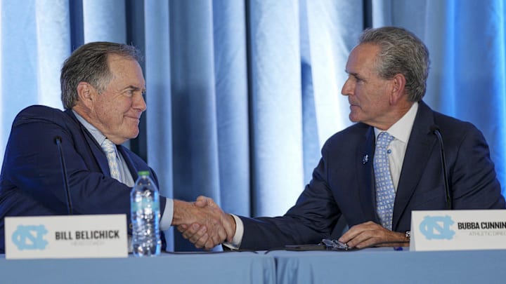 Dec 12, 2024; Chapel Hill, NC, USA;  North Carolina Tar Heels new head coach Bill Belichick shakes hands with athletic director Bubba Cunningham at Loudermilk Center for Excellence. Mandatory Credit: Jim Dedmon-Imagn Images