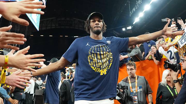 Apr 6, 2026; Indianapolis, IN, USA; Michigan Wolverines forward Morez Johnson Jr. (21) with fans after the National Championship of the Final Four of the men's 2026 NCAA Tournament at Lucas Oil Stadium. Mandatory Credit: Bob Donnan-Imagn Images Apr 6, 2026; Indianapolis, IN, USA; Michigan Wolverines forward Morez Johnson Jr. (21) with fans after the National Championship of the Final Four of the men's 2026 NCAA Tournament at Lucas Oil Stadium. Mandatory Credit: Bob Donnan-Imagn Images