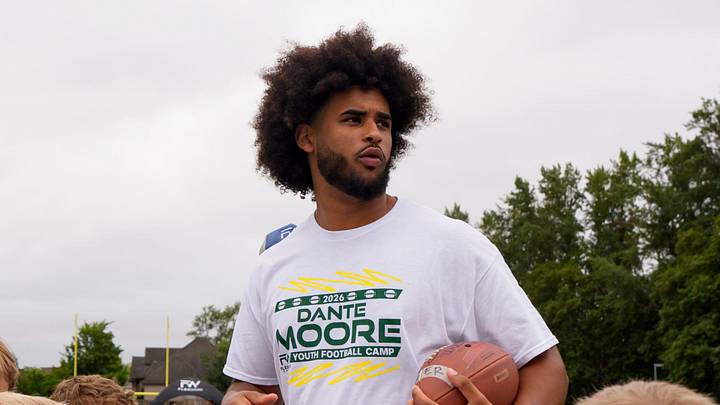 Oregon quarterback Dante Moore works with kids during a youth football camp at Marist Catholic High School on June 20, 2026, in Eugene, Oregon.