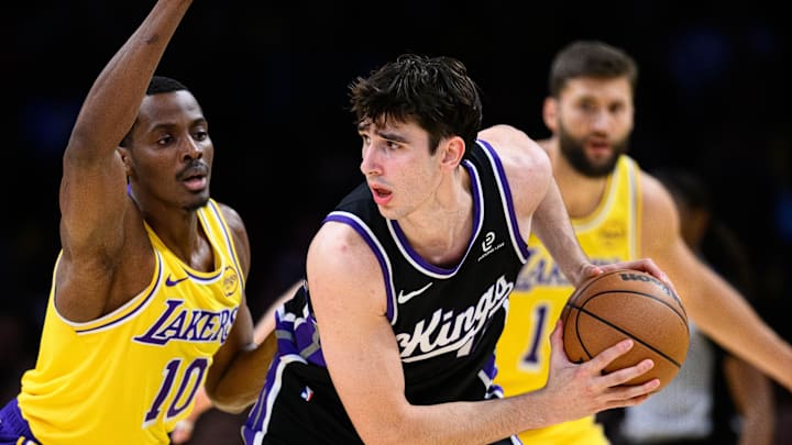 Oct 17, 2025; Los Angeles, California, USA; Sacramento Kings center Maxime Raynaud (42) looks to drive the ball while under pressure from Los Angeles Lakers center Christian Koloko (10) during the second half at Crypto.com Arena. Mandatory Credit: William Liang-Imagn Images