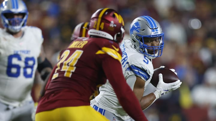 Detroit Lions running back David Montgomery (5) runs for a gain past Washington Commanders linebacker Von Miller (24) 