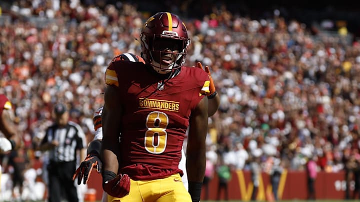 Oct 6, 2024; Landover, Maryland, USA; Washington Commanders running back Brian Robinson Jr. (8) celebrates after scoring a touchdown against the Cleveland Browns during the first quarter at NorthWest Stadium. Mandatory Credit: Geoff Burke-Imagn Images