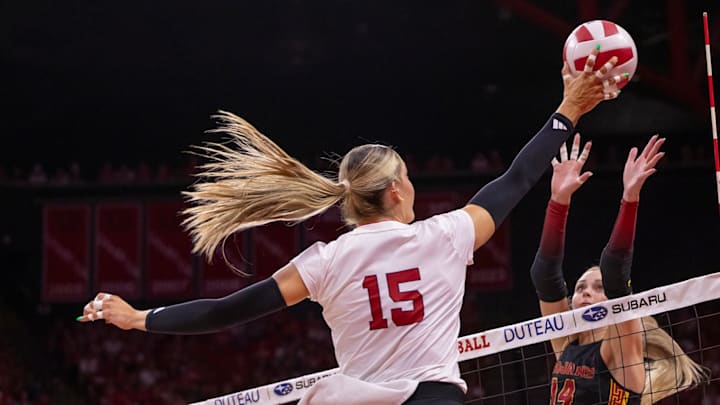 Nebraska middle blocker Andi Jackson (15) hits a ball over USC outside hitter Ally Batenhorst.