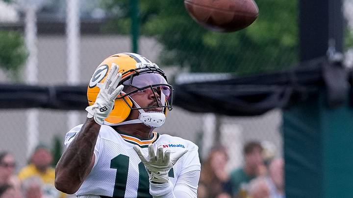 Green Bay Packers receiver Bo Melton (16) catches a punt during training camp. Green Bay Packers receiver Bo Melton (16) catches a punt during training camp.