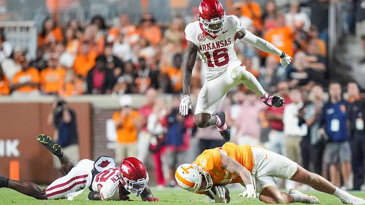 Arkansas defensive back Miguel Mitchell (16) leaps over Tennessee tight end Miles Kitselman (87) during a college football game between Tennessee and Arkansas at Neyland Stadium in Knoxville, Tenn., on Oct. 11, 2025. Arkansas defensive back Miguel Mitchell (16) leaps over Tennessee tight end Miles Kitselman (87) during a college football game between Tennessee and Arkansas at Neyland Stadium in Knoxville, Tenn., on Oct. 11, 2025.
