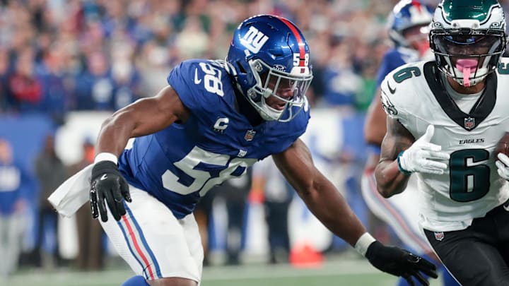 Oct 9, 2025; East Rutherford, New Jersey, USA; Philadelphia Eagles wide receiver DeVonta Smith (6) carries the ball defended by New York Giants linebacker Bobby Okereke (58) during the first quarter of the game at MetLife Stadium. 