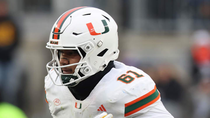 Nov 29, 2025; Pittsburgh, Pennsylvania, USA;  Miami Hurricanes offensive lineman Francis Mauigoa (61) blocks against Pittsburgh Panthers defensive lineman Joey Zelinsky (45) during the third quarter at Acrisure Stadium. Mandatory Credit: Charles LeClaire-Imagn Images