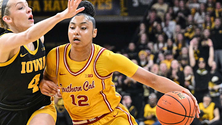 Feb 2, 2025; Iowa City, Iowa, USA; USC Trojans guard JuJu Watkins (12) drives with the ball as Iowa Hawkeyes guard Kylie Feuerbach (4) defends and center Rayah Marshall (13) looks on during the first quarter at Carver-Hawkeye Arena. Mandatory Credit: Jeffrey Becker-Imagn Images
