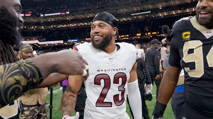 Dec 15, 2024; New Orleans, Louisiana, USA; New Orleans Saints linebacker Demario Davis (56) greets former teammate Washington Commanders cornerback Marshon Lattimore (23) next to New Orleans Saints defensive end Cameron Jordan (94) at the end of the game at Caesars Superdome. Mandatory Credit: Matthew Hinton-Imagn Images
