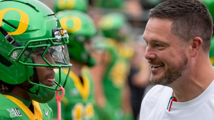 Oregon head coach Dan Lanning, right, talks with Oregon wide receiver Dakorien Moore during warmups as the Oregon Ducks host the Oklahoma State Cowboys on Sept. 6, 2025, at Autzen Stadium in Eugene, Oregon.