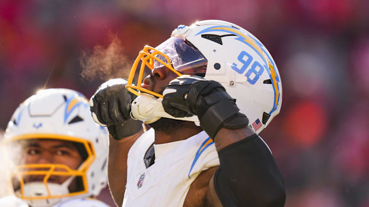 Dec 14, 2025; Kansas City, Missouri, USA; Los Angeles Chargers linebacker Odafe Oweh (98) celebrates a sack against the Kansas City Chiefs during the second half at GEHA Field at Arrowhead Stadium. Mandatory Credit: Jay Biggerstaff-Imagn Images