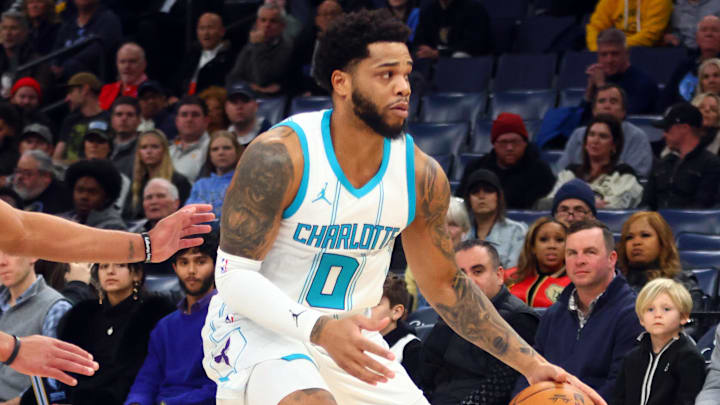 Jan 22, 2025; Memphis, Tennessee, USA; Charlotte Hornets forward Miles Bridges (0) dribbles as Memphis Grizzlies guard Desmond Bane (22) defends during the first quarter at FedExForum. Mandatory Credit: Petre Thomas-Imagn Images