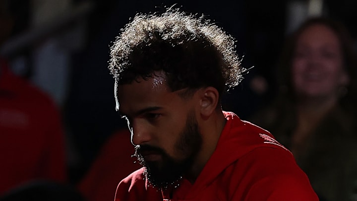 Trae Young looks to the ground on the bench before a match against the Chicago Bulls.