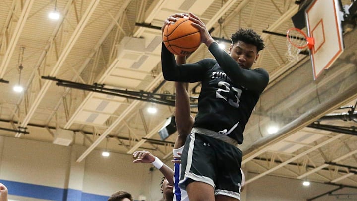 Thompson High guard Colben Landrew (23) pulls a rebound at Tuscaloosa County High School.