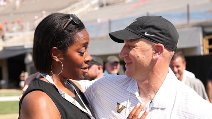Candice Storey Lee and Clark Lea share a moment before a game.