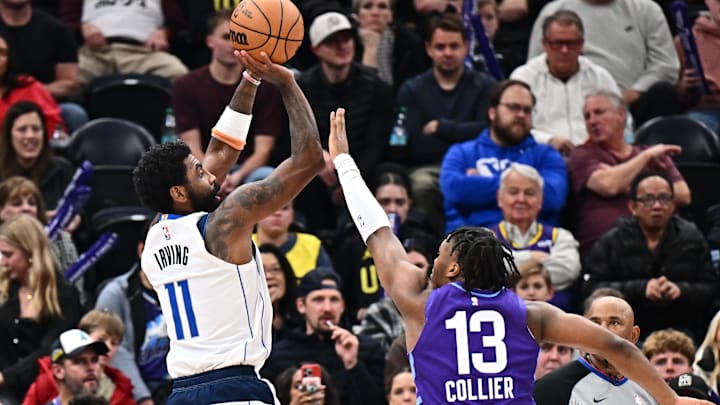 Nov 30, 2024; Salt Lake City, Utah, USA;  Dallas Mavericks guard Kyrie Irving (11) shoots over Utah Jazz guard Isaiah Collier (13) in the second half at Delta Center. Mandatory Credit: Jamie Sabau-Imagn Images