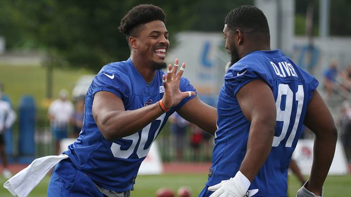 Defensive linemen Greg Rousseau, (50), left, and Ed Oliver, (91), right, joke around at Bills practice. Defensive linemen Greg Rousseau, (50), left, and Ed Oliver, (91), right, joke around at Bills practice.