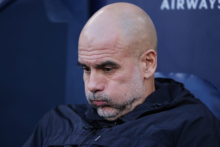 Pep Guardiola puffing out his cheeks.