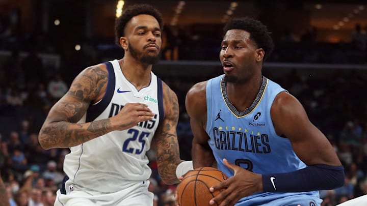 Nov 7, 2025; Memphis, Tennessee, USA; Memphis Grizzlies forward/center Jaren Jackson Jr. (8) drives to the basket against Dallas Mavericks forward P.J. Washington (25) during the second quarter at FedExForum. Mandatory Credit: Petre Thomas-Imagn Images