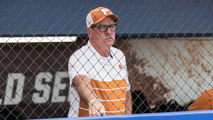 Texas Longhorns head coach Mike White watches the Texas Tech Red Raiders warm up before game one of the NCAA Softball Women's College World Series finals. Texas Longhorns head coach Mike White watches the Texas Tech Red Raiders warm up before game one of the NCAA Softball Women's College World Series finals.