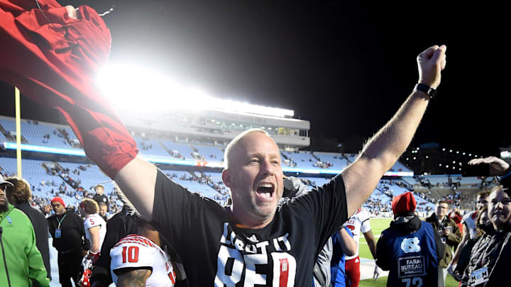 Nov 25, 2022; Chapel Hill, North Carolina, USA; North Carolina State Wolfpack head coach Dave Doeren celebrates after the game at Kenan Memorial Stadium. Mandatory Credit: Bob Donnan-Imagn Images Nov 25, 2022; Chapel Hill, North Carolina, USA; North Carolina State Wolfpack head coach Dave Doeren celebrates after the game at Kenan Memorial Stadium. Mandatory Credit: Bob Donnan-Imagn Images