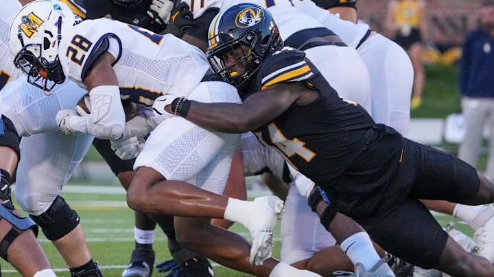 Aug 29, 2024; Columbia, Missouri, USA; Murray State Racers running back Jordan Washington (28) runs the ball as Missouri Tigers linebacker Triston Newson (14) makes the tackle during the game at Faurot Field at Memorial Stadium. Mandatory Credit: Denny Medley-Imagn Images Aug 29, 2024; Columbia, Missouri, USA; Murray State Racers running back Jordan Washington (28) runs the ball as Missouri Tigers linebacker Triston Newson (14) makes the tackle during the game at Faurot Field at Memorial Stadium. Mandatory Credit: Denny Medley-Imagn Images