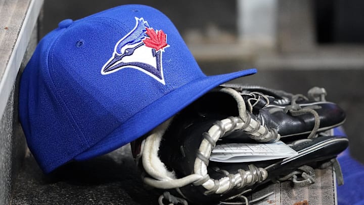 Apr 16, 2025; Toronto, Ontario, CAN; A Toronto Blue Jays hat and glove in the dugout during a game against the Atlanta Braves at Rogers Centre. Apr 16, 2025; Toronto, Ontario, CAN; A Toronto Blue Jays hat and glove in the dugout during a game against the Atlanta Braves at Rogers Centre.