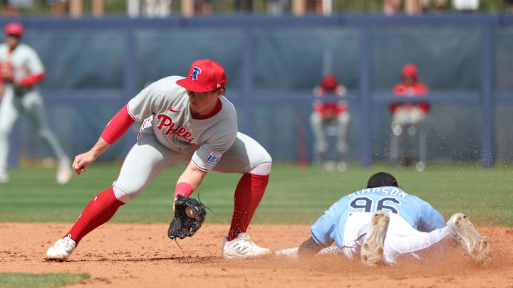 Feb 25, 2025; Port Charlotte, Florida, USA;  Tampa Bay Rays outfielder Chandler Simpson (96) slides safely into second base against Philadelphia Phillies infielder Aidan Miller (81) at Charlotte Sports Park.