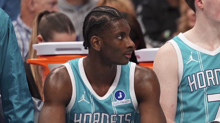 Feb 9, 2026; Charlotte, North Carolina, USA; Charlotte Hornets forward Moussa Diabaté (14) and guard/forward Kon Knueppel (7) and guard LaMelo Ball (1) get a break during the second quarter against the Detroit Pistons at Spectrum Center. Mandatory Credit: Jim Dedmon-Imagn Images