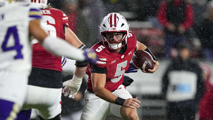 Nov 8, 2025; Madison, Wisconsin, USA; Wisconsin Badgers quarterback Carter Smith (5) rushes with the football during the third quarter against the Washington Huskies at Camp Randall Stadium. Mandatory Credit: Jeff Hanisch-Imagn Images Nov 8, 2025; Madison, Wisconsin, USA; Wisconsin Badgers quarterback Carter Smith (5) rushes with the football during the third quarter against the Washington Huskies at Camp Randall Stadium. Mandatory Credit: Jeff Hanisch-Imagn Images