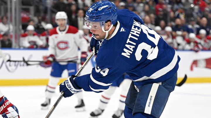 Sep 19, 2026; Toronto, Ontario, CAN;  Toronto Maple Leafs forward Auston Matthews (34) shoots the puck as Montreal Canadiens defenseman Noah Dobson (53) defends in the first period at Scotiabank Arena.  Mandatory Credit: Dan Hamilton-Imagn Images