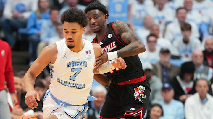 Feb 23, 2026; Chapel Hill, North Carolina, USA; North Carolina Tar Heels guard Seth Trimble (7) dribbles as Louisville Cardinals guard Kobe Rodgers (11) defends in the second half at Dean E. Smith Center. Mandatory Credit: Bob Donnan-Imagn Images