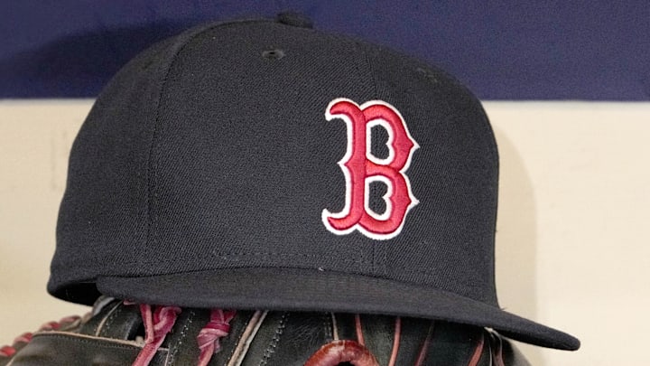 May 27, 2025; Milwaukee, Wisconsin, USA; A Boston Red Sox hat and glove sit in the dug out before a game against the Milwaukee Brewers at American Family Field.
