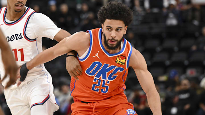 Nov 2, 2024; Inglewood, California, USA; Oklahoma City Thunder guard Ajay Mitchell (25) drives the ball against LA Clippers guard Jordan Miller (11) during the second half at Intuit Dome. Mandatory Credit: Jonathan Hui-Imagn Images