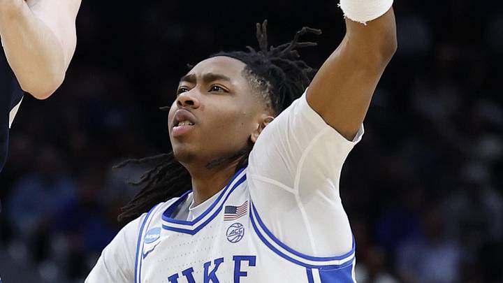 Mar 29, 2026; Washington, DC, USA; UConn Huskies guard Braylon Mullins (24) passes the ball between Duke Blue Devils forward Maliq Brown (6) and Blue Devils guard Isaiah Evans (3) in the second half during an Elite Eight game of the East Regional of the men's 2026 NCAA Tournament at Capital One Arena. Mandatory Credit: Amber Searls-Imagn Images
