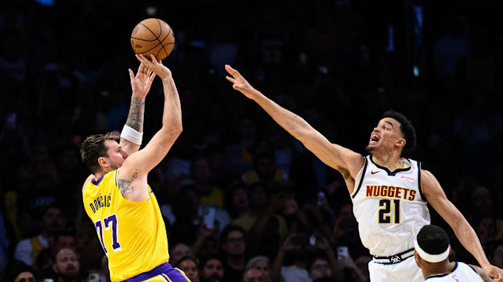 Mar 14, 2026; Los Angeles, California, USA; Los Angeles Lakers guard Luka Doncic (77) shoots a game-winning shot while under pressure from Denver Nuggets forward Spencer Jones (21) during overtime at Crypto.com Arena. Mandatory Credit: William Liang-Imagn Images Mar 14, 2026; Los Angeles, California, USA; Los Angeles Lakers guard Luka Doncic (77) shoots a game-winning shot while under pressure from Denver Nuggets forward Spencer Jones (21) during overtime at Crypto.com Arena. Mandatory Credit: William Liang-Imagn Images