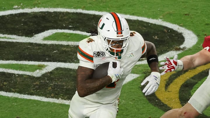 Jan 19, 2026; Miami Gardens, FL, USA; Miami Hurricanes running back Mark Fletcher Jr. (4) carries the ball defended by Indiana Hoosiers linebacker Aiden Fisher (4) in the third quarter during the College Football Playoff National Championship game at Hard Rock Stadium. Mandatory Credit: Kim Klement Neitzel-Imagn Images