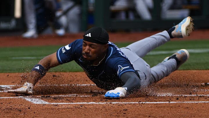 Mar 29, 2026; St. Louis, Missouri, USA; Tampa Bay Rays left fielder Chandler Simpson (14) slides head first in to home and scores against the St. Louis Cardinals during the second inning at Busch Stadium. 