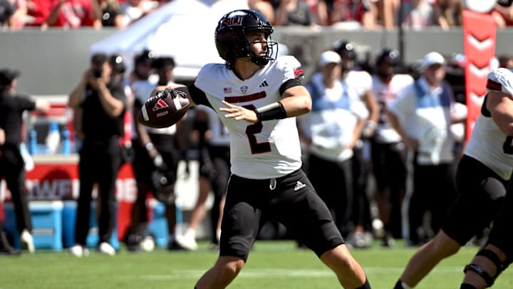 Sep 28, 2024; Raleigh, North Carolina, USA;  Northern Illinois Huskies quarterback Ethan Hampton (2) throws a pass against the North Carolina State Wolfpack in the first quarter at Carter-Finley Stadium. Mandatory Credit: Zachary Taft-Imagn Images