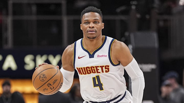 Dec 8, 2024; Atlanta, Georgia, USA; Denver Nuggets guard Russell Westbrook (4) brings the ball up the court against the Atlanta Hawks during the first half at State Farm Arena.