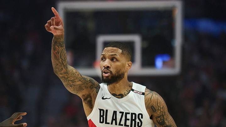 Oct 21, 2026; Portland, Oregon, USA; Portland Trail Blazers guard Damian Lillard (0) signals to teammates during the first half against Phoenix Suns center Khaman Maluach (10) at Moda Center. Mandatory Credit: Troy Wayrynen-Imagn Images
