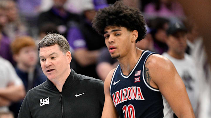 Jan 10, 2026; Fort Worth, Texas, USA; Arizona Wildcats head coach Tommy Lloyd talks with forward Koa Peat (10) during the second half against the TCU Horned Frogs at the Ed and Rae Schollmaier Arena. Mandatory Credit: Jerome Miron-Imagn Images
