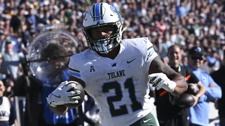 Nov 16, 2024; Annapolis, Maryland, USA;  Tulane Green Wave running back Makhi Hughes (21) scores a touchdown during the first half against the Navy Midshipmen at Navy-Marine Corps Memorial Stadium
