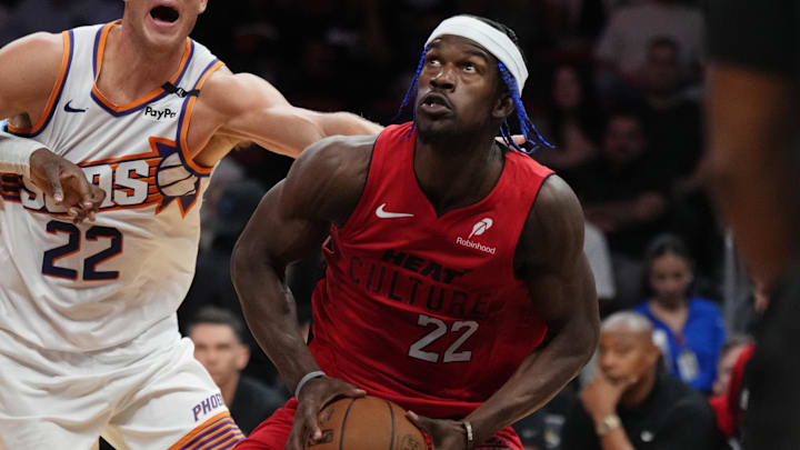 Dec 7, 2024; Miami, Florida, USA;  Miami Heat forward Jimmy Butler (22) drives to the basket against Phoenix Suns center Mason Plumlee (22) during the second half at Kaseya Center. Mandatory Credit: Jim Rassol-Imagn Images