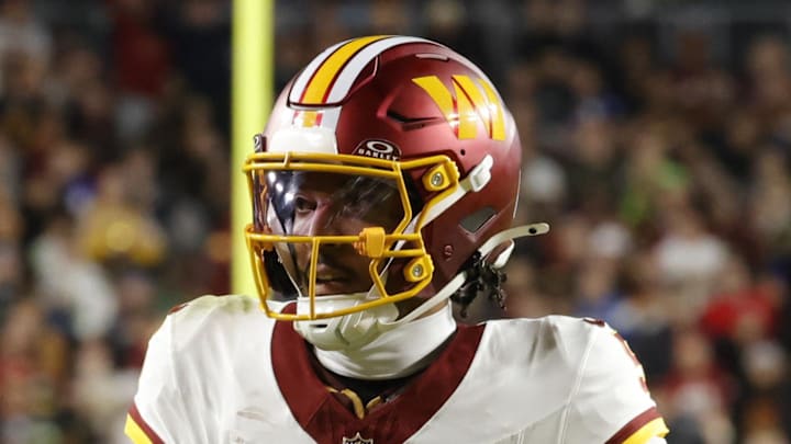 Washington Commanders quarterback Jayden Daniels runs the ball against the Seattle Seahawks.