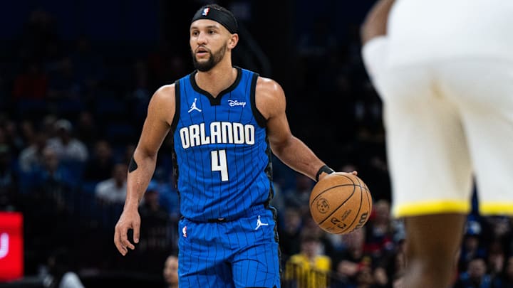 Feb 29, 2024; Orlando, Florida, USA; Orlando Magic guard Jalen Suggs (4) dribbles the ball against the Utah Jazz in the first quarter at Kia Center. Feb 29, 2024; Orlando, Florida, USA; Orlando Magic guard Jalen Suggs (4) dribbles the ball against the Utah Jazz in the first quarter at Kia Center.