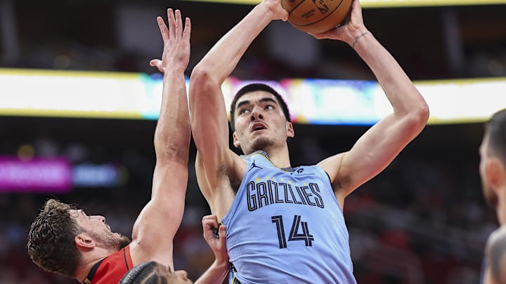 Oct 25, 2024; Houston, Texas, USA; Memphis Grizzlies center Zach Edey (14) shoots the ball over Houston Rockets center Alperen Sengun (28) during the second quarter at Toyota Center. Mandatory Credit: Troy Taormina-Imagn Images