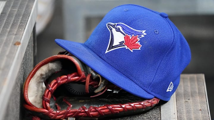 Apr 16, 2025; Toronto, Ontario, CAN; A Toronto Blue Jays hat and glove in the dugout during a game against the Atlanta Braves at Rogers Centre. 
